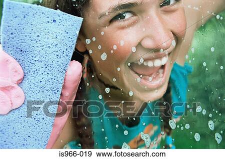 Girl cleaning glass with sponge View Large Photo Image Stock Photo - Girl cleaning glass with sponge. Fotosearch
