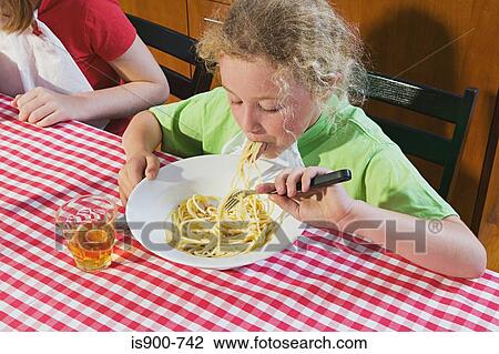 Girl eating spaghetti View Large Photo Image Stock Image - Girl eating spaghetti. Fotosearch