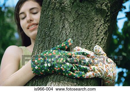 Girl hugging tree trunk View Large Photo Image Picture - Girl hugging tree trunk. Fotosearch