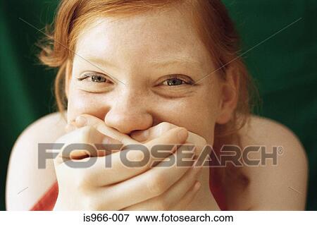 Girl laughing with hands over mouth View Large Photo Image Stock Photo - Girl laughing with hands over mouth. Fotosearch