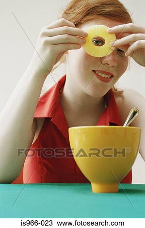 Girl looking through hole in slice of fruit View Large Photo Image Stock Image - Girl looking through hole in slice of fruit. Fotosearch