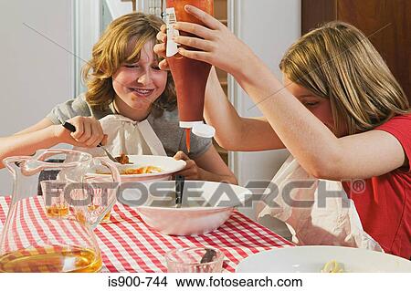 Picture - Girls eating messily. Fotosearch