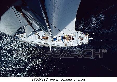 Stock Photo - Sunbather on sailboat. Fotosearch