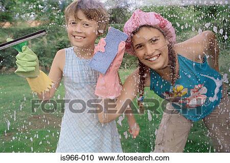 Two girls cleaning window View Large Photo Image Stock Image - Two girls cleaning window. Fotosearch