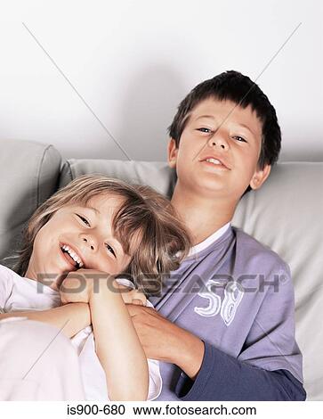 Boy and girl on sofa View Large Photo Image Stock Image - Boy and girl on sofa. Fotosearch