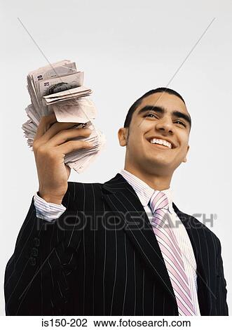 Businessman with wad of cash View Large Photo Image Stock Image - Businessman with wad of cash. Fotosearch