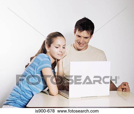 Couple using laptop View Large Photo Image Stock Photo - Couple using laptop. Fotosearch