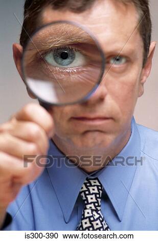 Man holding a magnifying glass View Large Photo Image Stock Image - Man holding a magnifying glass. Fotosearch