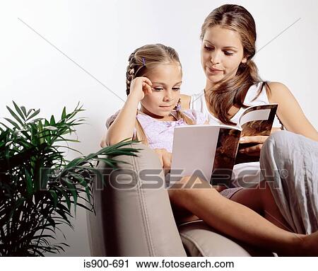 Stock Image - Mother and daughter reading. Fotosearch