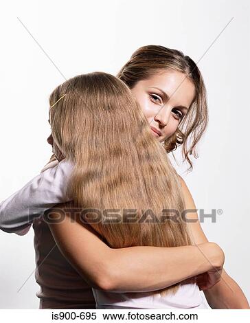 Mother hugging daughter View Large Photo Image Stock Photography - Mother hugging daughter. Fotosearch