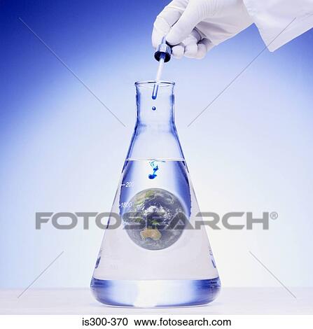 Stock Image - Scientist adding chemical to the world. Fotosearch