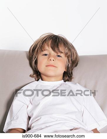 Picture - Young boy on sofa. Fotosearch
