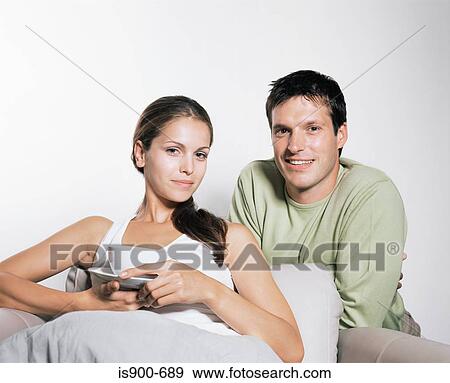 Young couple on sofa View Large Photo Image Stock Photo - Young couple on sofa. Fotosearch