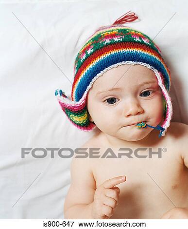 Stock Photo - Baby wearing a knitted hat. Fotosearch