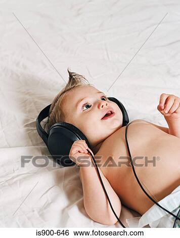 Stock Photograph - baby wearing headphones. Fotosearch