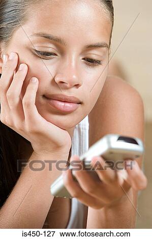 Girl with a remote control View Large Photo Image Stock Photo - Girl with a remote control. Fotosearch