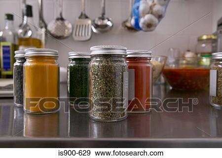 Jars filled with herbs and spices in kitchen View Large Photo Image Stock Photo - Jars filled with herbs and spices in kitchen. Fotosearch