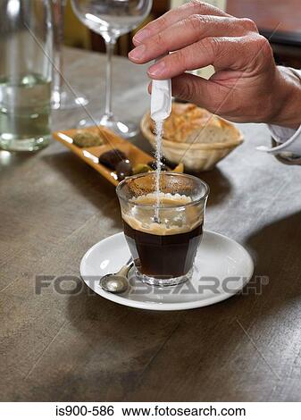 Man adding sugar to espresso coffee View Large Photo Image Stock Photograph - Man adding sugar to espresso coffee. Fotosearch