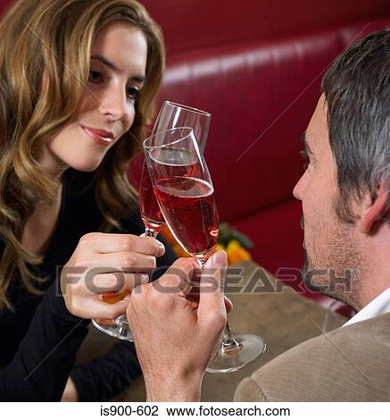 Stock Image - Man and woman toasting with champagne. Fotosearch