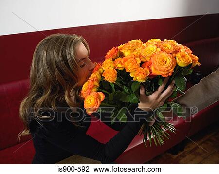 Stock Image - Man giving woman a bunch of roses. Fotosearch