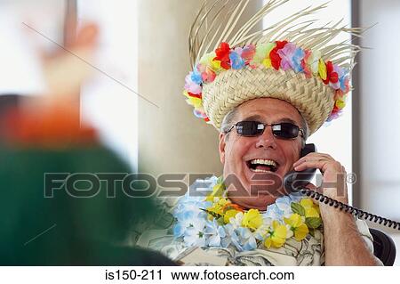 Stock Image - Man on telephone wearing holiday clothes. Fotosearch