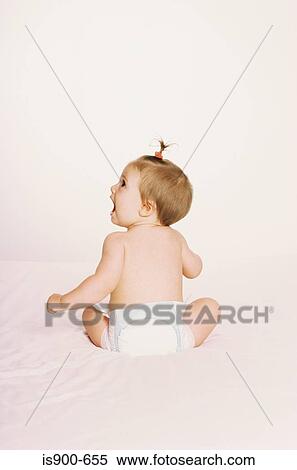 Stock Photography - Rear view of baby sitting. Fotosearch