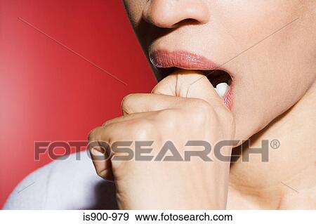 Woman biting her knuckle View Large Photo Image Stock Photo - Woman biting her knuckle. Fotosearch