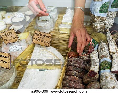 Woman reaching into delicatessen display View Large Photo Image Stock Photo - Woman reaching into delicatessen display. Fotosearch
