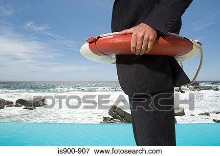 Businessman wearing a lifebelt View Large Photo Image Stock Photo - Businessman wearing a lifebelt. Fotosearch