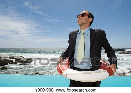Stock Photo - Businessman wearing a lifebelt. Fotosearch