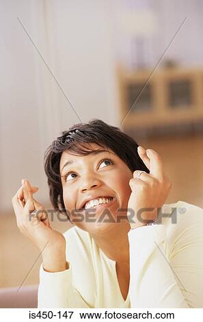 Stock Photo - Woman crossing her fingers. Fotosearch