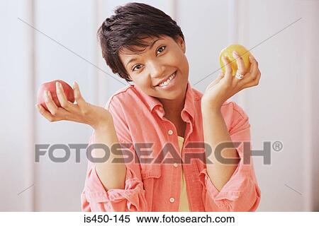 Woman with apple and orange View Large Photo Image Stock Photography - Woman with apple and orange. Fotosearch