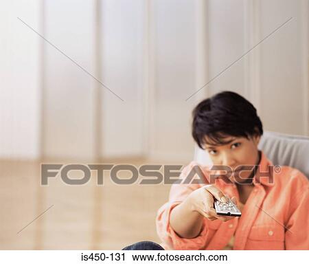 Woman with remote control View Large Photo Image Stock Image - Woman with remote control. Fotosearch
