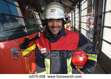 Fireman holding a football View Large Photo Image Stock Photo - Fireman holding a football. Fotosearch