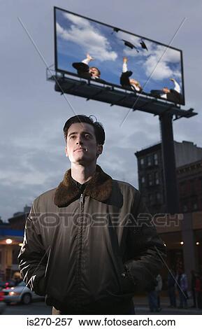 Stock Photo - Man daydreaming by billboard. Fotosearch