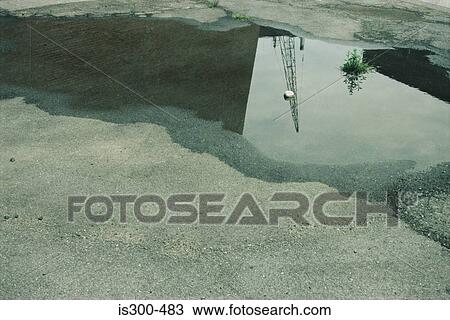 Stock Image - Puddle in a road. Fotosearch