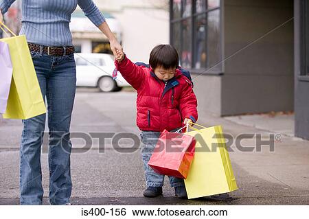 Boy and mother shopping View Large Photo Image Stock Photograph - Boy and mother shopping. Fotosearch