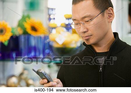 Man texting in shop View Large Photo Image Picture - Man texting in shop. Fotosearch