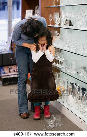 Mother comforting daughter over broken glass View Large Photo Image Stock Photo - Mother comforting daughter over broken glass. Fotosearch