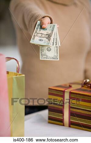 Paying for gifts with dollars View Large Photo Image Stock Photograph - Paying for gifts with dollars. Fotosearch