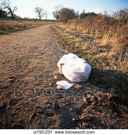 Rubbish left by a path View Large Photo Image Stock Photo - Rubbish left by a path. Fotosearch