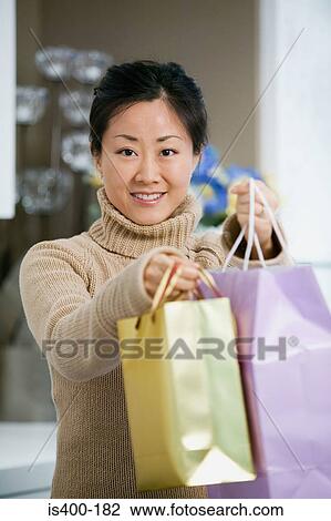 Woman holding shopping bags View Large Photo Image Stock Image - Woman holding shopping bags. Fotosearch