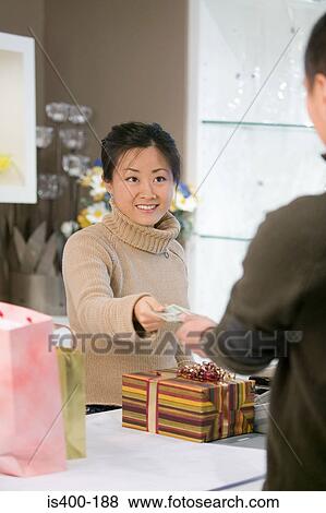 Woman paying for gifts View Large Photo Image Stock Photo - Woman paying for gifts. Fotosearch