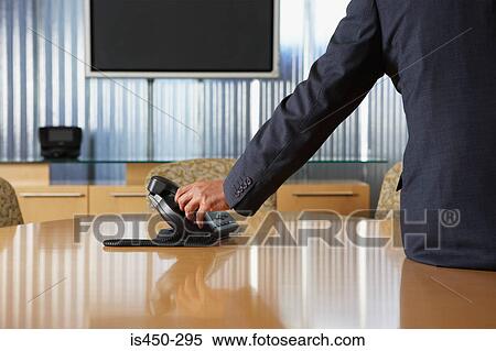 Businessman lifting telephone receiver View Large Photo Image Stock Photography - Businessman lifting telephone receiver. Fotosearch