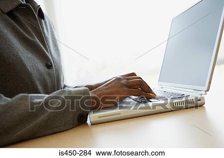 Picture - Businesswoman using laptop. Fotosearch