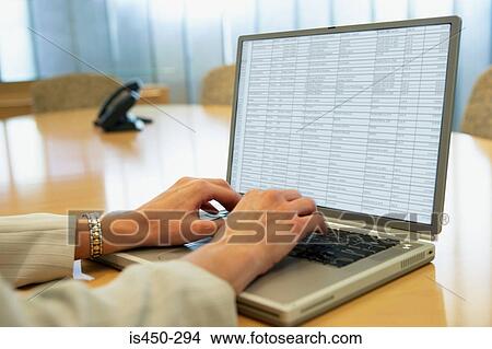 Picture - Businesswoman using laptop. Fotosearch