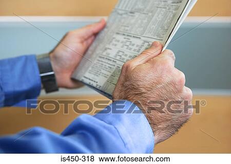 Man holding newspaper View Large Photo Image Stock Photo - Man holding newspaper. Fotosearch