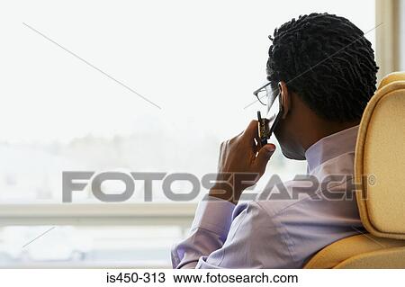 Stock Image - Man on cellphone. Fotosearch