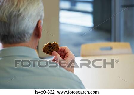 Man with a cookie View Large Photo Image Stock Image - Man with a cookie. Fotosearch