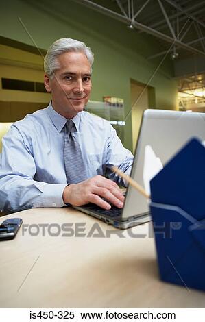 Man working at desk View Large Photo Image Stock Photography - Man working at desk. Fotosearch